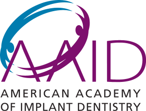 The image is a logo of the American Academy of Implant Dentistry. It features a stylized graphic with text, including  AID  prominently displayed in the center.